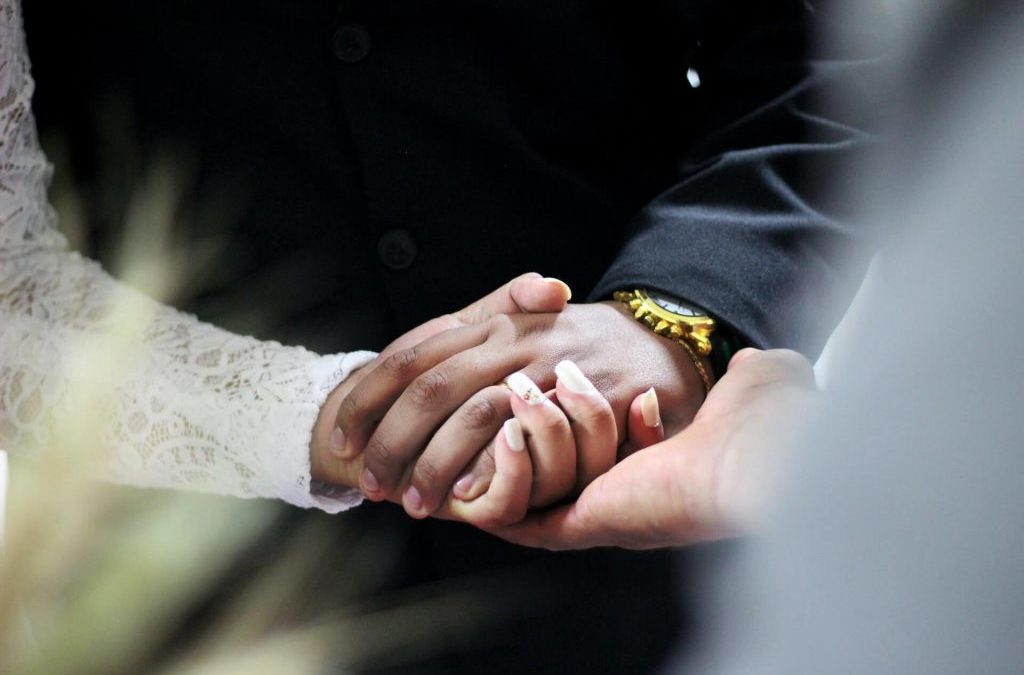 couple holding hands how to calm wedding day nerves with the celebrant angel