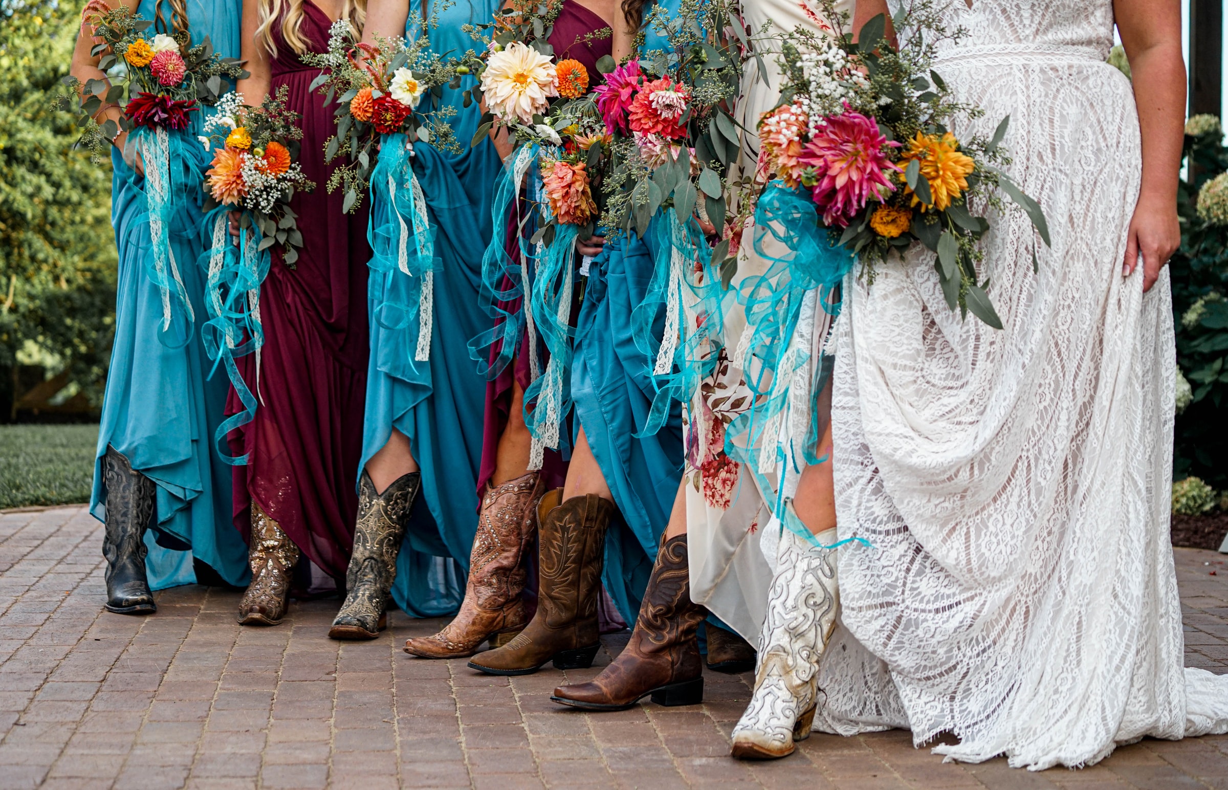 tai-s-captures-NSDvnMBEkyI-unsplash brides maids all dressed in long dresses with cowboy boots on