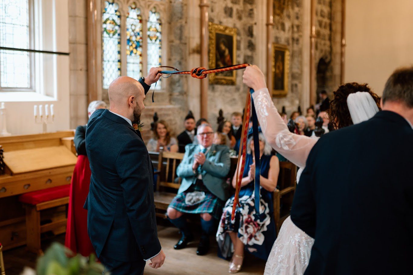 rowan and martin having a hand fasting ritual in their ceremony