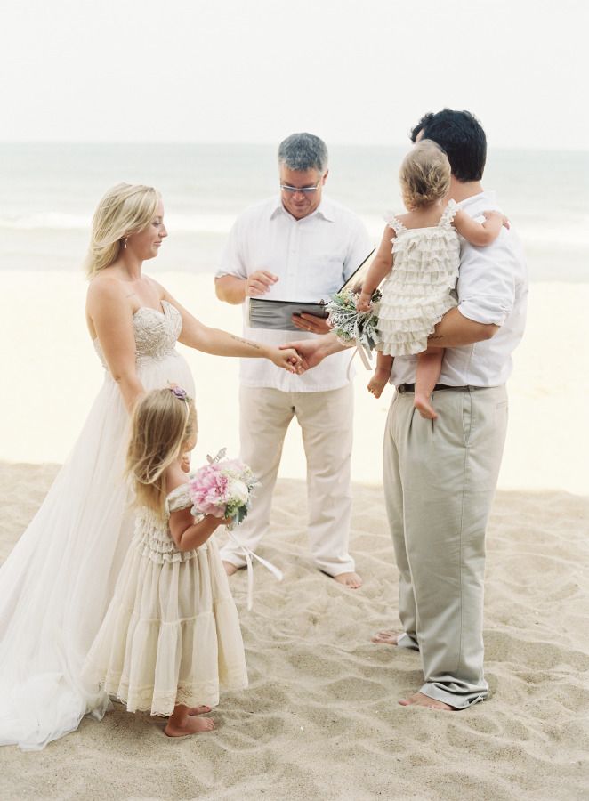 The Sweetest Atlantic Coast Family Vow Renewal couple and their children on a beach doing a vow renewal ceremony
