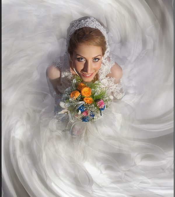 bride holding flowers looking up into the photographers camera how to choose a wedding photographer in aberdeen