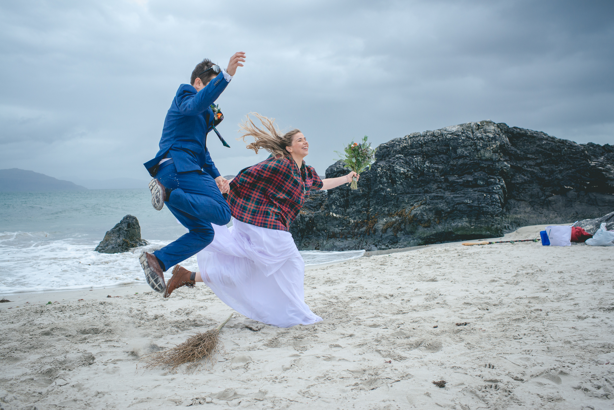 iona elopement 2020 couple jumping the broom on an beach