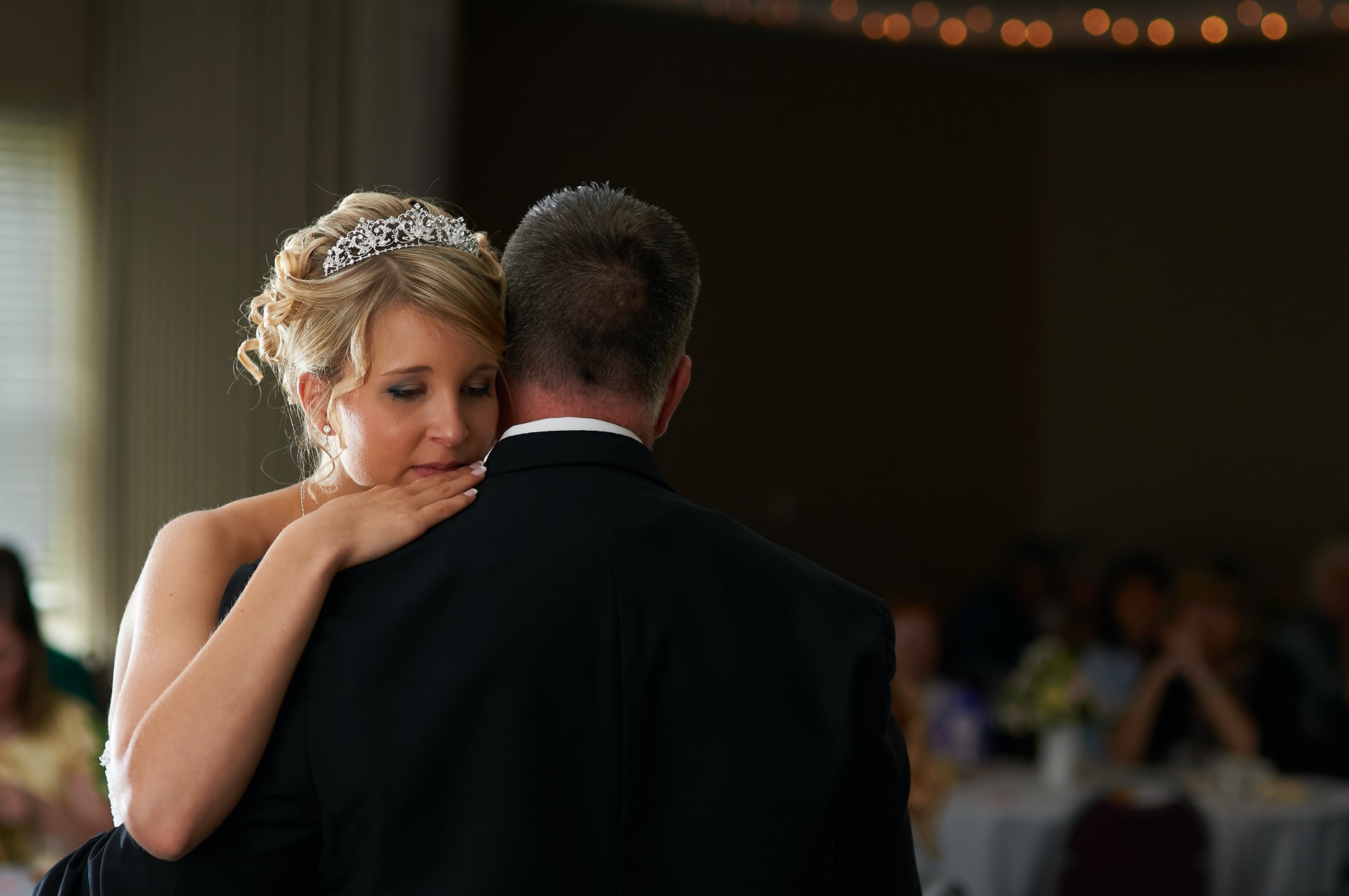 chip-vincent-N3o09BYK-Ys-unsplash bride with her head on partners shoulder crying, how to calm wedding day nerves
