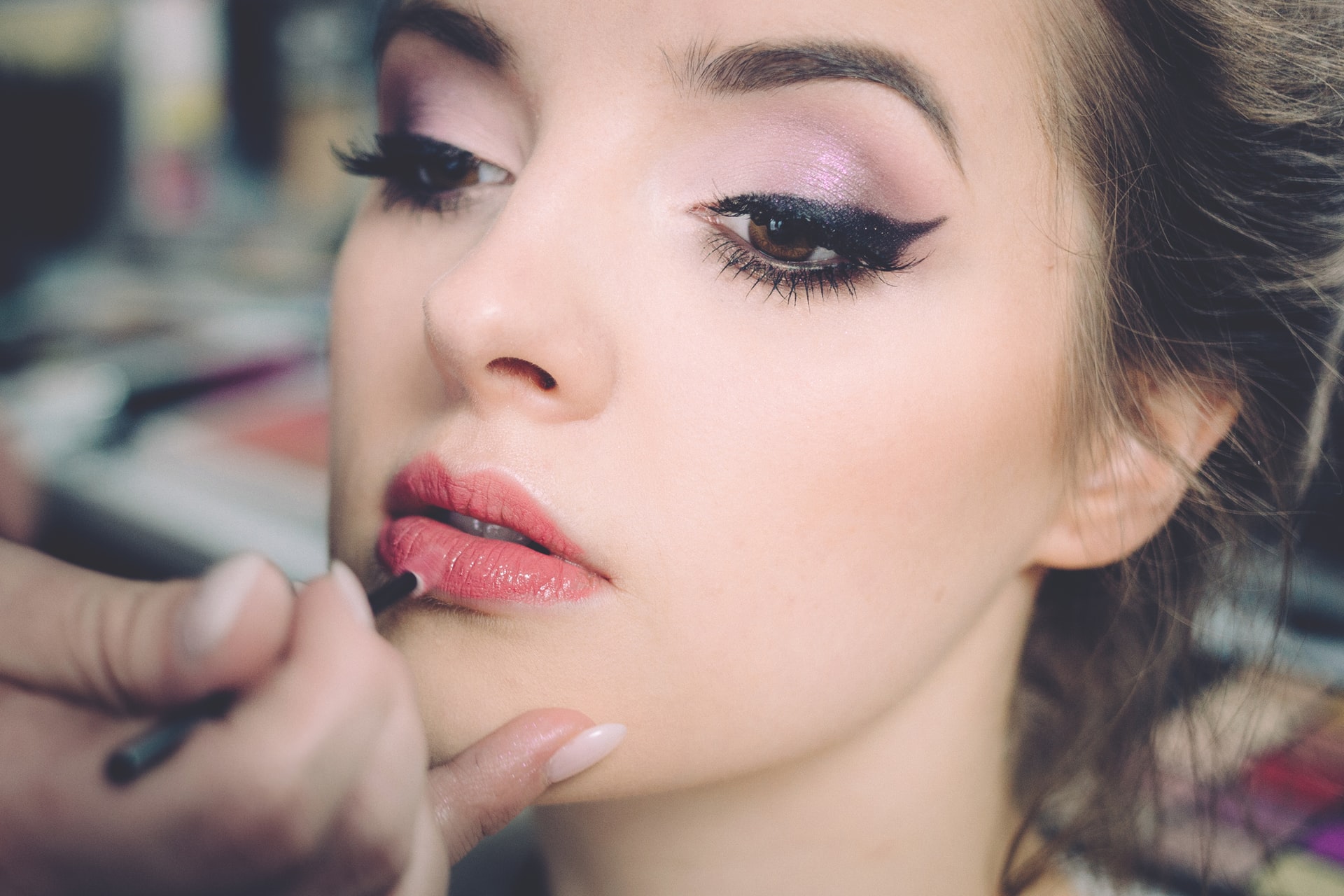 freestocks-YGmk9UZMdZg-unsplash photo of lipstick being applied by make up artist how to calm wedding day nerves with the celebrant angel