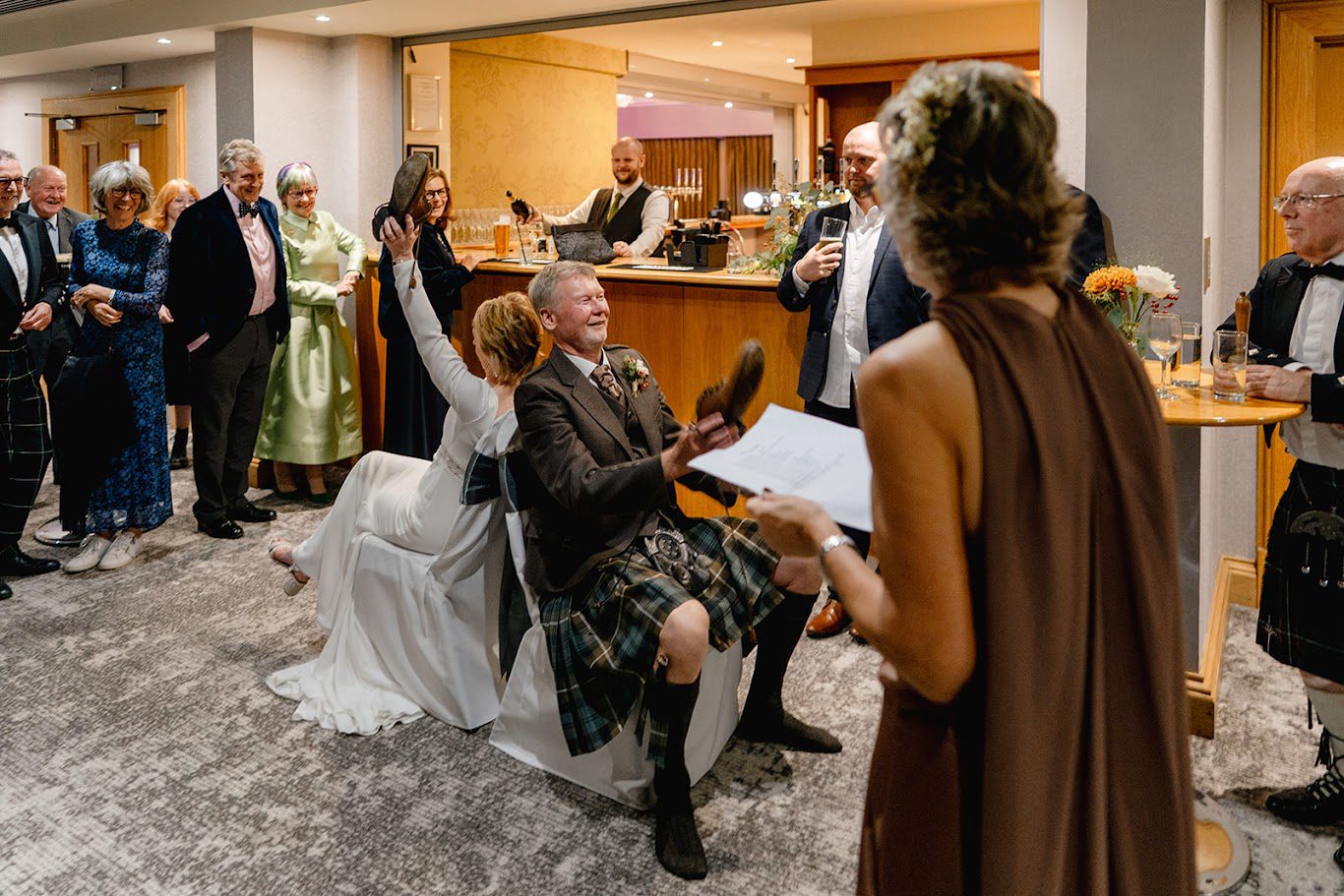 a photo of a couple playing the wedding shoe game at Rufflets hotel in St Andrews with mary gibson the celebrant angel aberdeen celebrant 