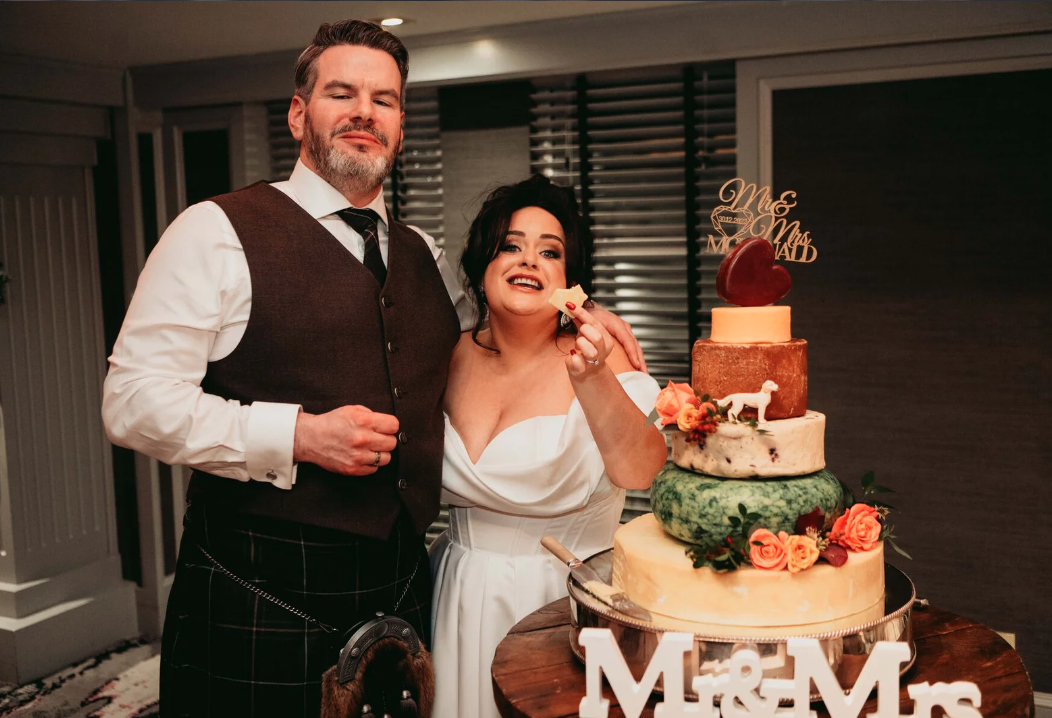 claire and marc eating cake and the marcliffe hotel with mary gibson the celebrant angel aberdeen, humanist wedding celebrant