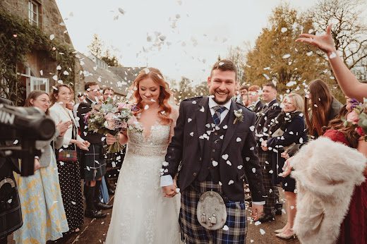 Martin and Leanne's walking through the confetti at the wedding at Aswanley venue