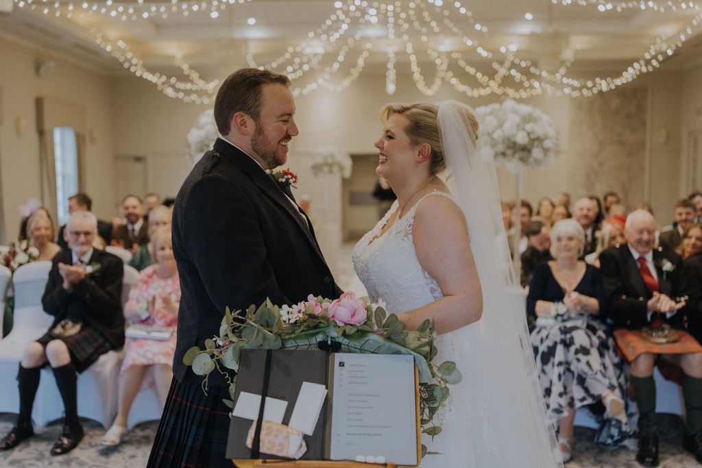 photo of a scott and frances onder on their wedding day smiling at each other, wedding was at maryculter house hotel with mary gibson the celebrant angel