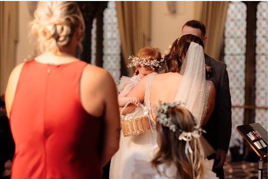 a photo of jen and sean in their wedding ceremony holding their daughter at union kirk aberdeen with mary gibson the celebrant angel aberdeen