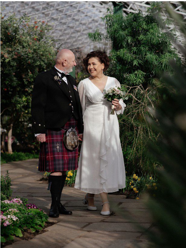 a couple doing their first kiss as husband and wife in their wedding ceremony at Meldrum House