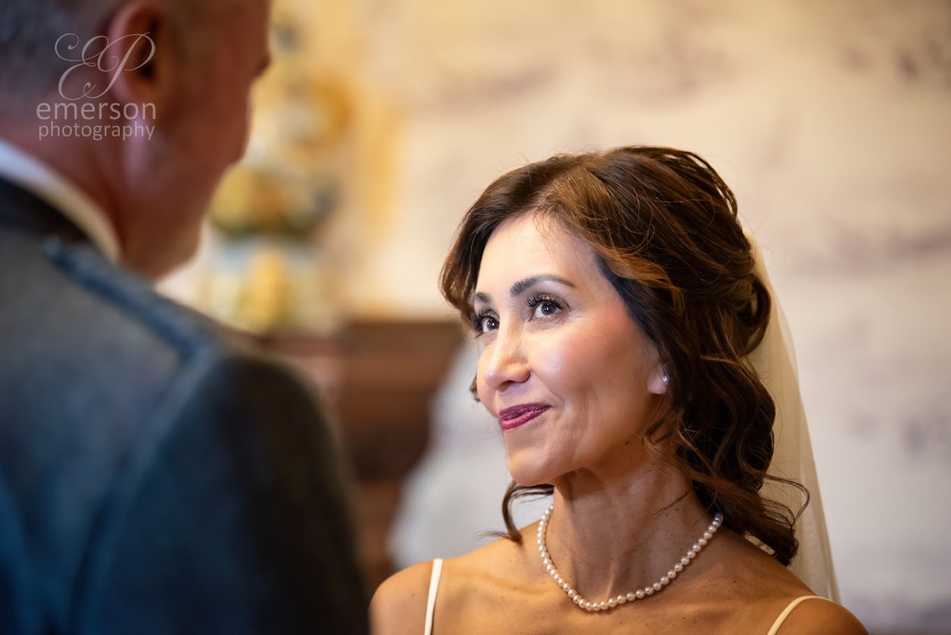 A bride with a cheeky grin on her face during her wedding ceremony at Ardoe House Aberdeen