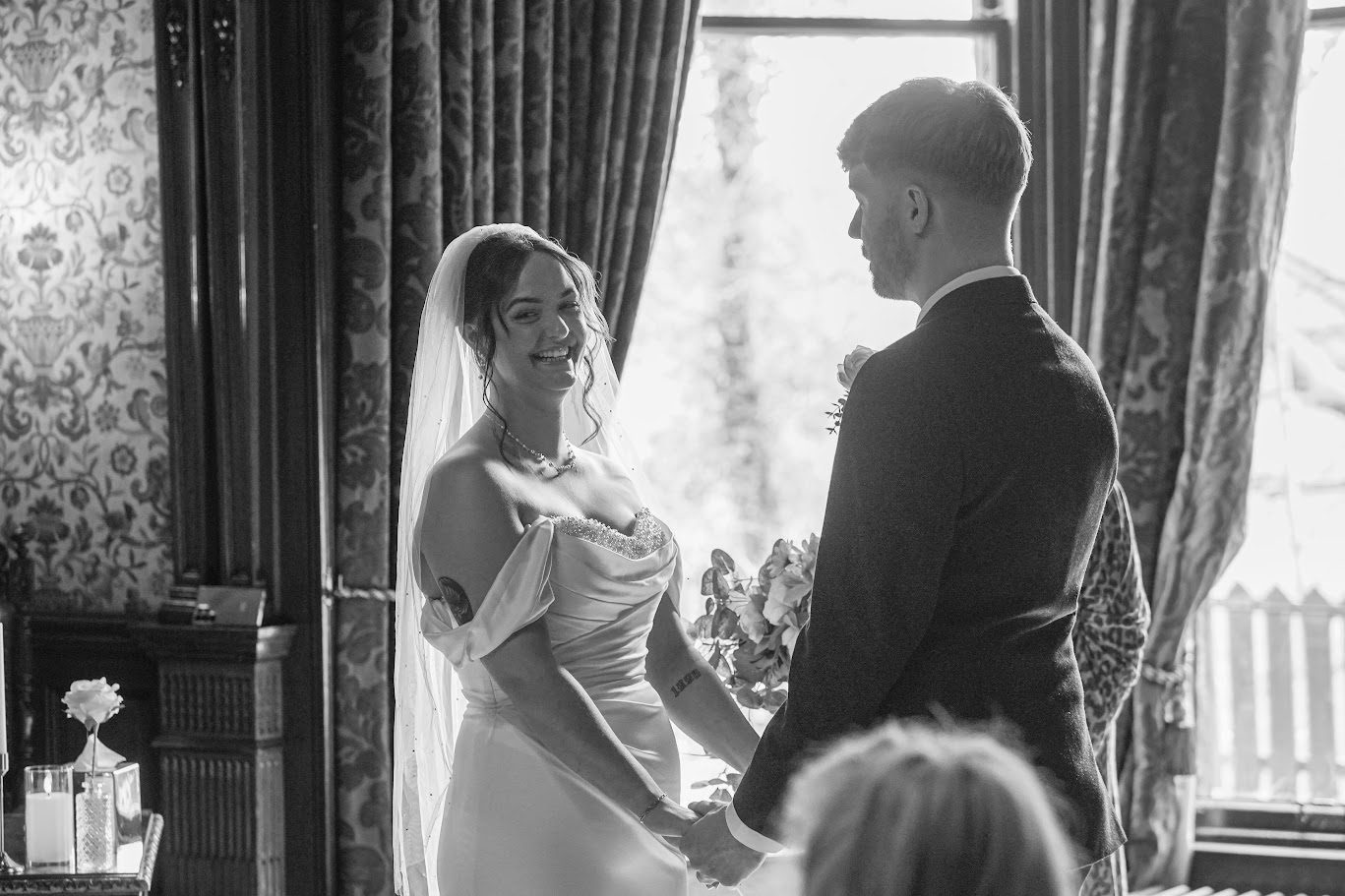 kara and liam laughing during their ceremony at Norwood Hall Aberdeen wedding venue