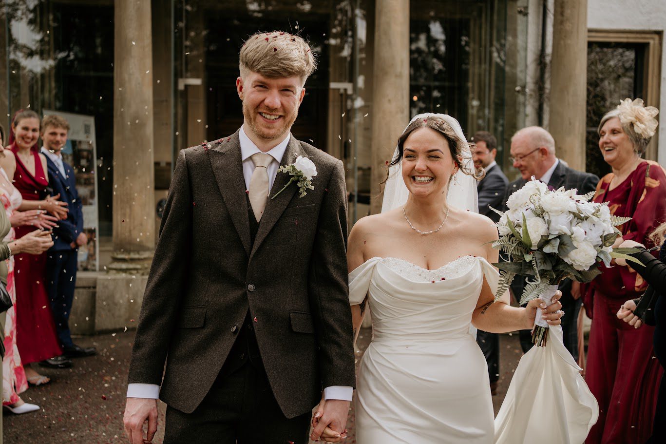 kara and liam doing the confetti walk at Norwood Hall Aberdeen wedding venue
