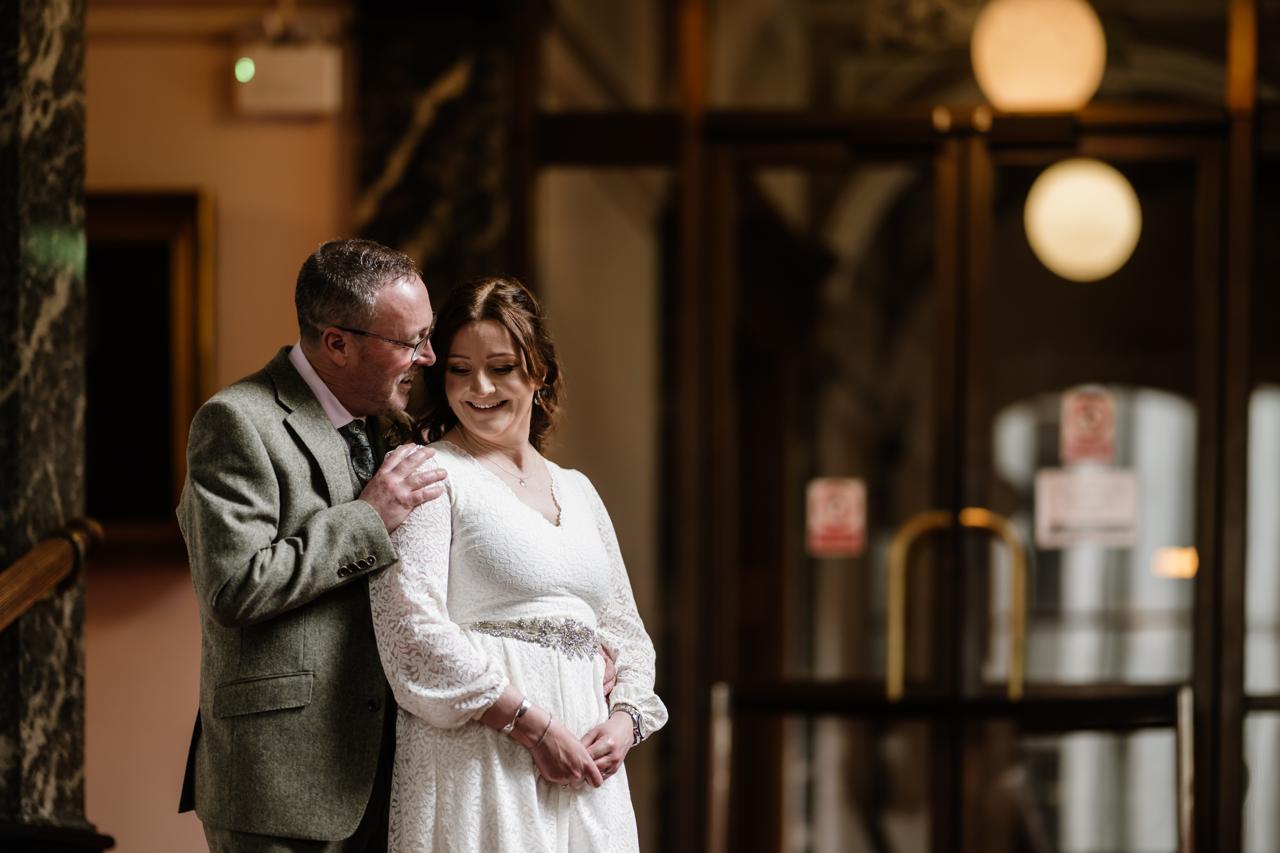 Claire and Richard Nicol standing on the steps of the Society of Advocates library in Aberdeen after their wedding ceremony
