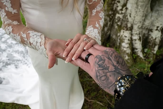 Courtney and Tris hands with wedding rings on at Pittodrie House Hotel